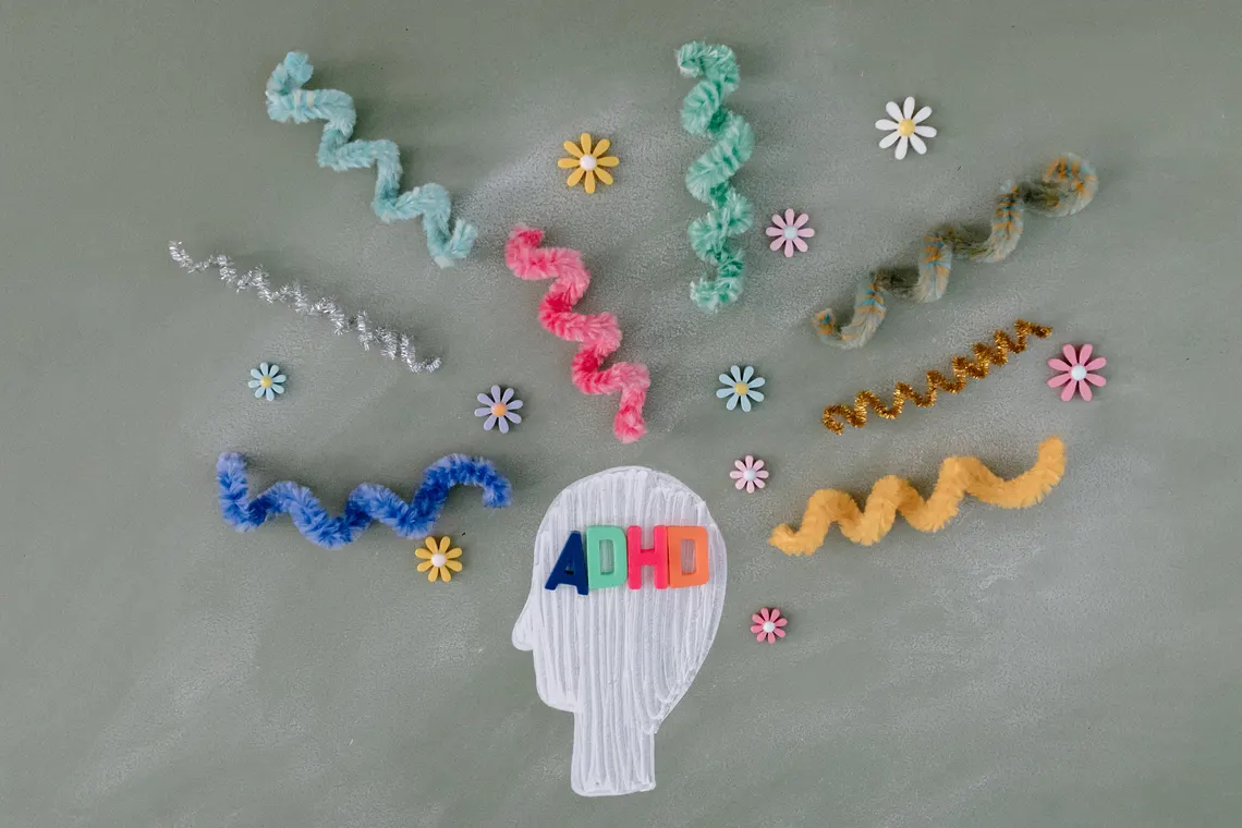 Wooden letter tiles spelling out ADHD